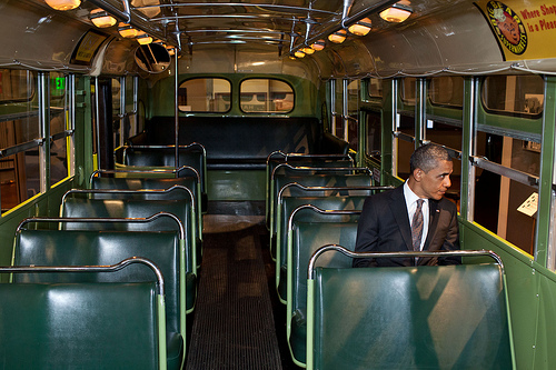 President Barack Obama sits on the Rosa Parks bus