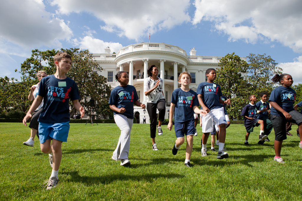 First Lady Michelle Obama runs with kids during the 