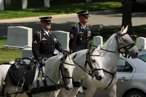 Staff Sgt. John Ford rides in formation during a ceremony at Arlington
