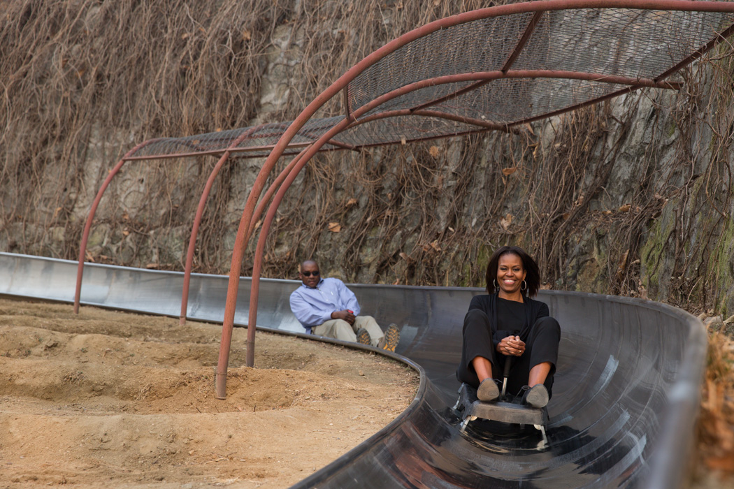 First Lady Michelle Obama takes a toboggan ride after visiting the Great Wall of China