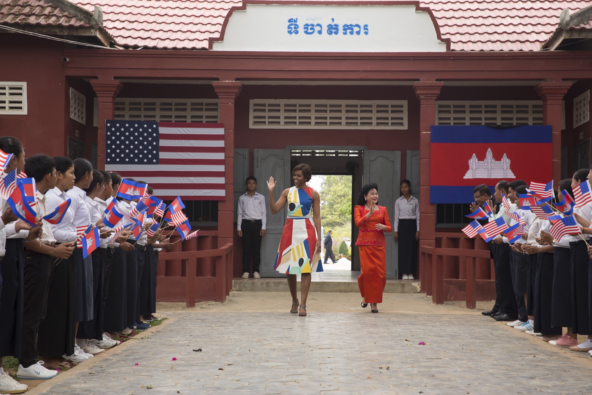 First Lady Michelle Obama and Mrs. Bun Rany Hun, First Lady of Cambodia, are greeted by students