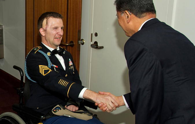 Sgt. 1st Class Cory Remsburg (left) shakes hands with Secretary Eric Shinseki before the State of the Union address.