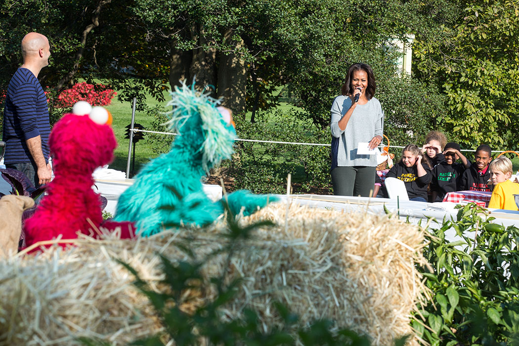 First Lady Michelle Obama, with Sesame Street’s Elmo and Rosita, join students for the annual fall harvest of the White House Kitchen Garden