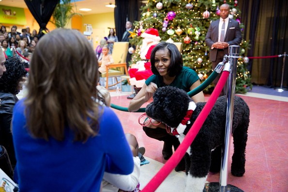 First Lady Michelle Obama visits with children and families during a Christmas holiday program