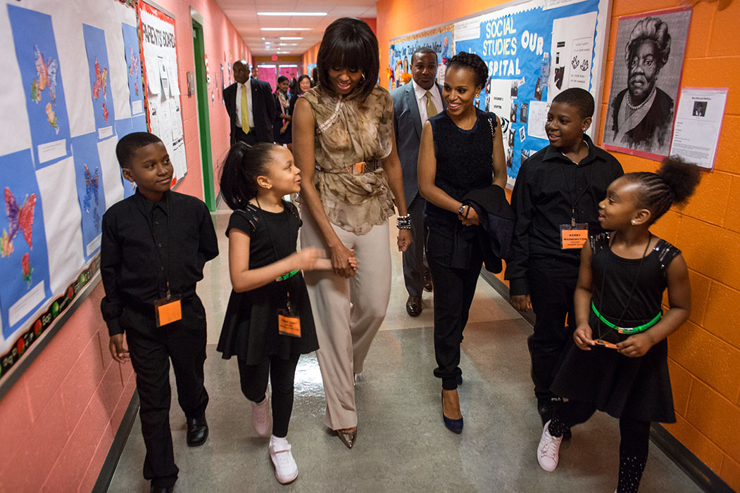 First lady Michelle Obama and Kerry Washington are escorted between classes by students