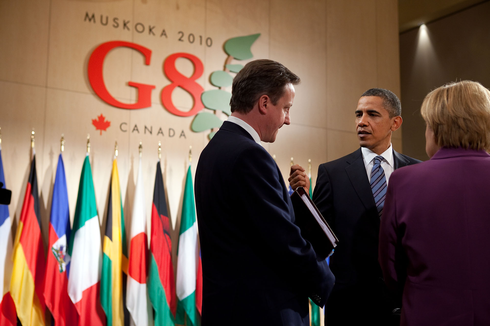 President Barack Obama talks with British Prime Minister David Cameron and German Chancellor Angela Merkel at G8 Summit in Canada