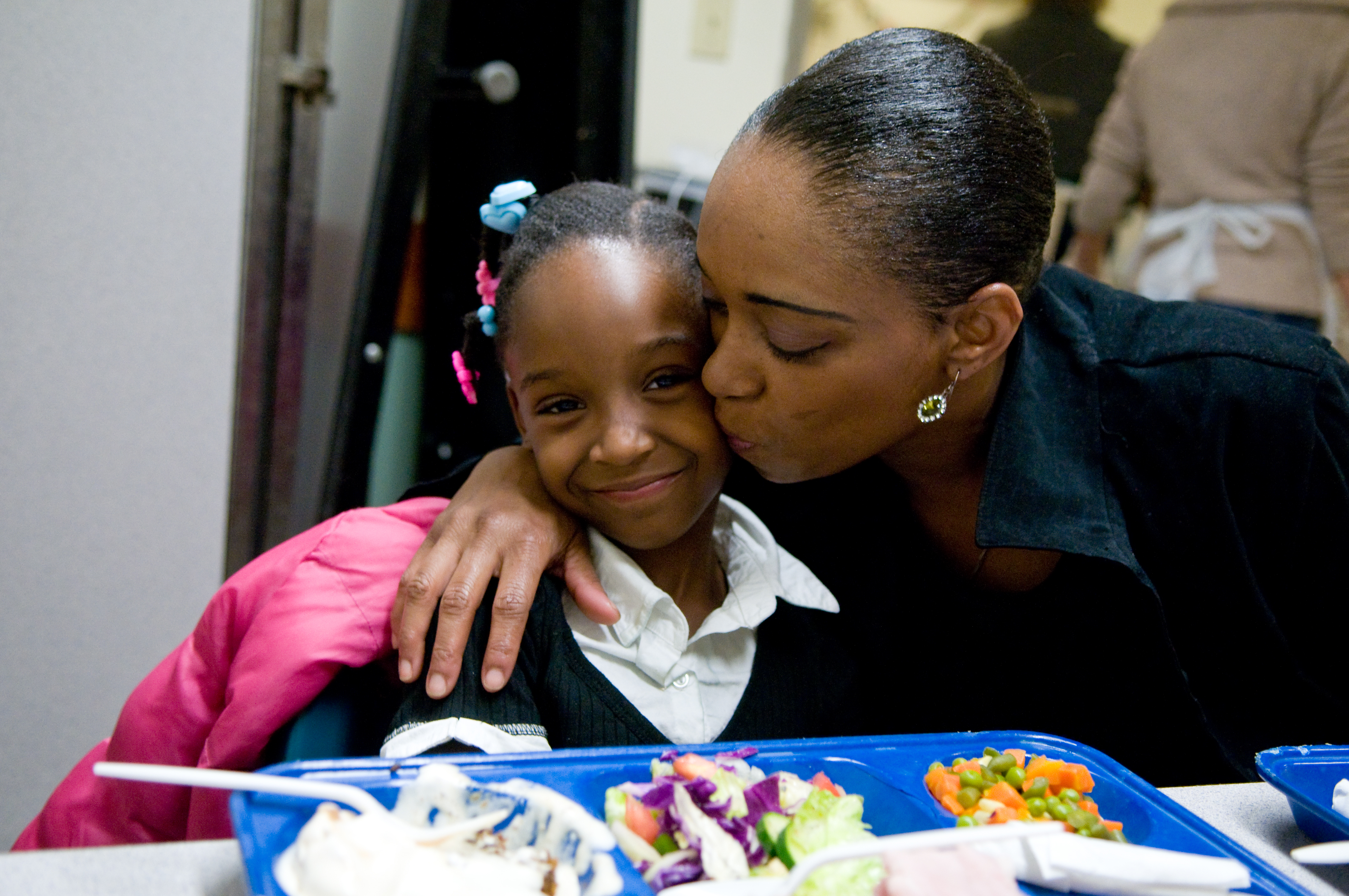 A mother and daughter sharing a meal in GLIDE’s Daily Free Meals Program