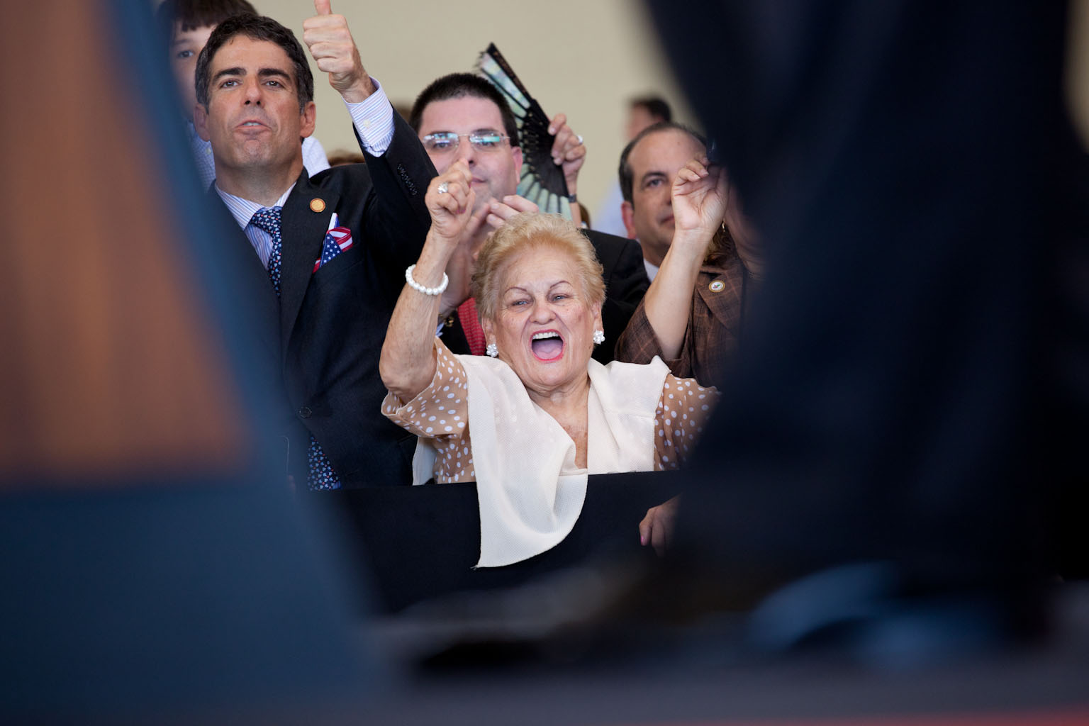 A woman cheers at the arrival ceremony at Luis Munoz Marin