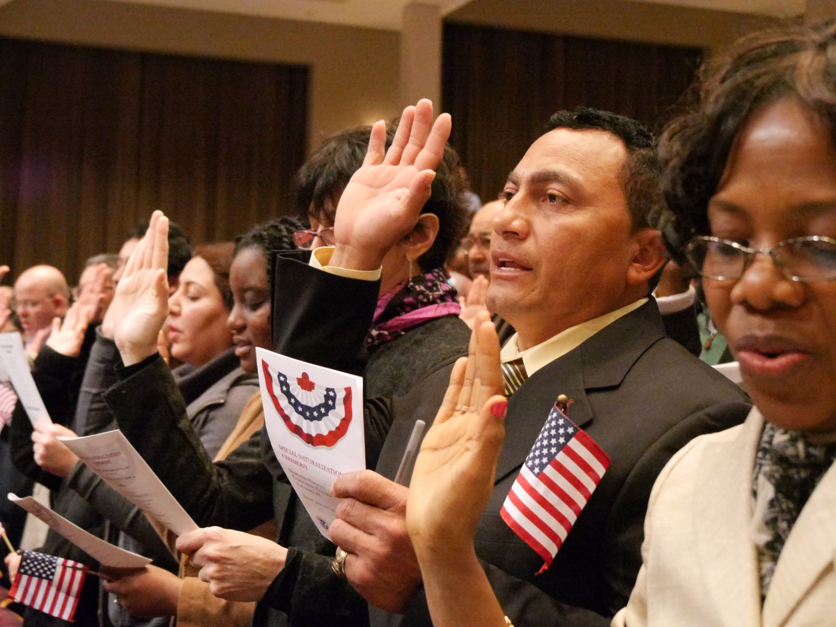 men and women participating in Naturalization ceremony