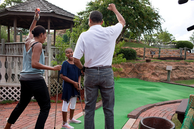 President Barack Obama and First Lady Michelle Obama play mini golf with daughter Sasha in Panama City Beach, Fla