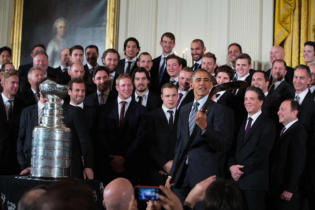 President Obama Examines Engraved Hockey Stick