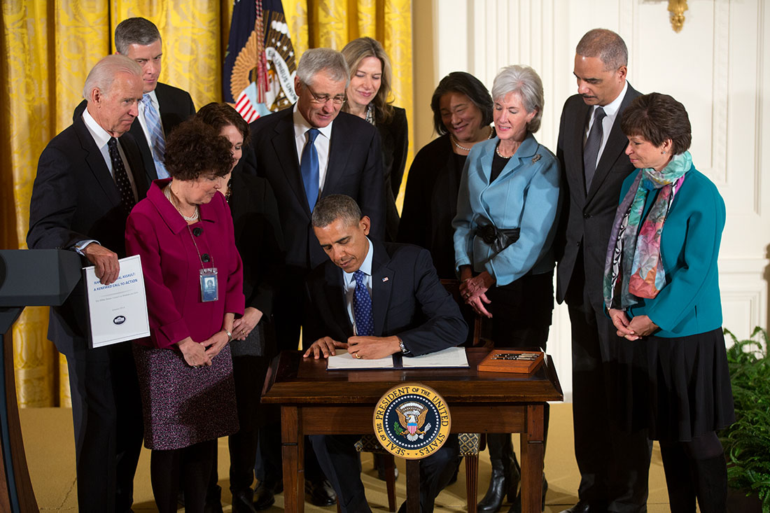President Barack Obama signs the Campus Sexual Assault Presidential Memorandum during a White House Council on Women and Girls meeting in the East Room of the White House, Jan. 22, 2014. 