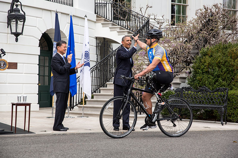 President Barack Obama high-fives a rider in the Wounded Warrior Project’s Soldier Ride on the South Lawn, April 17, 2013. 