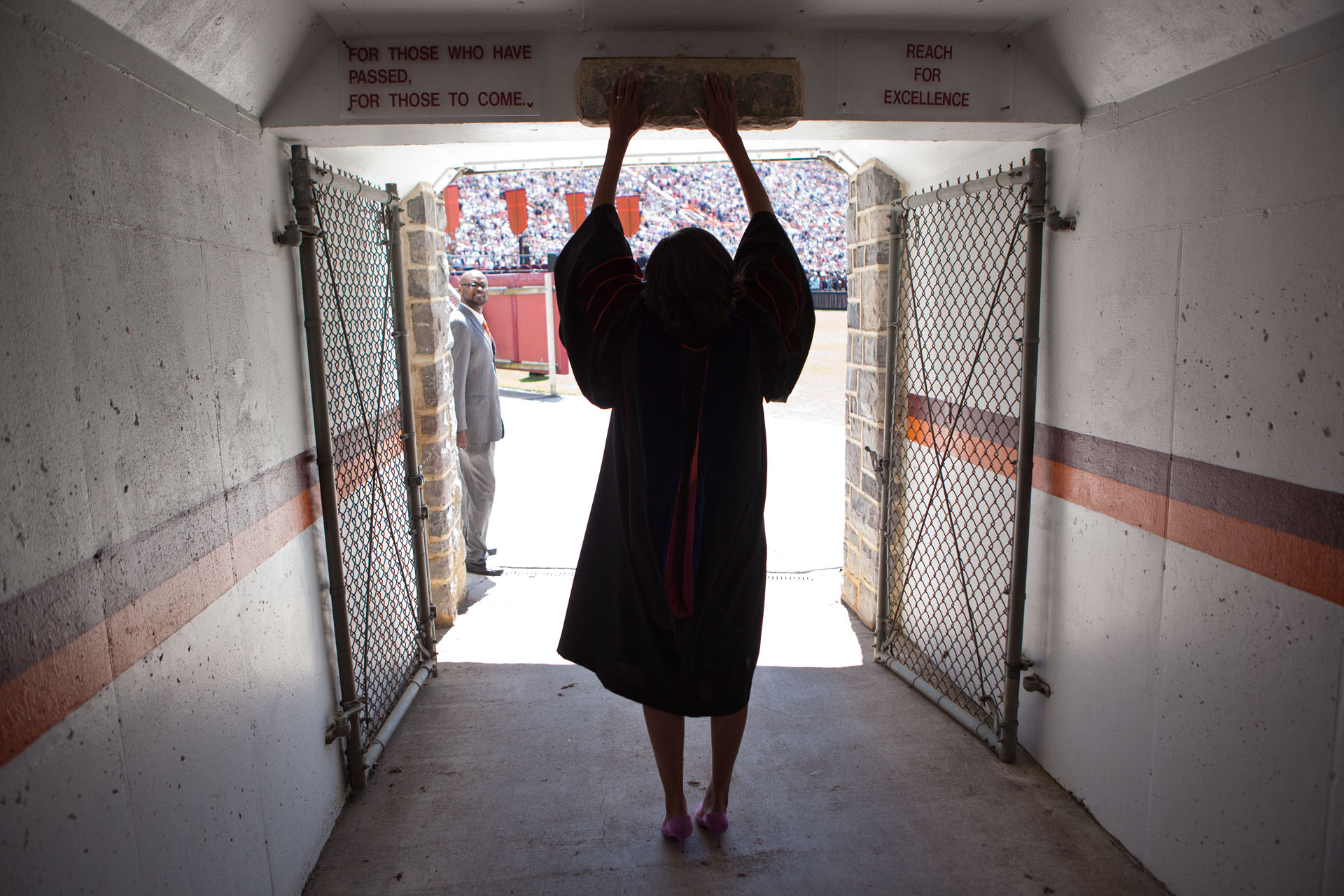 First Lady Michelle Obama touches the Hokie Stone as She Enters the Virginia Tech Stadium