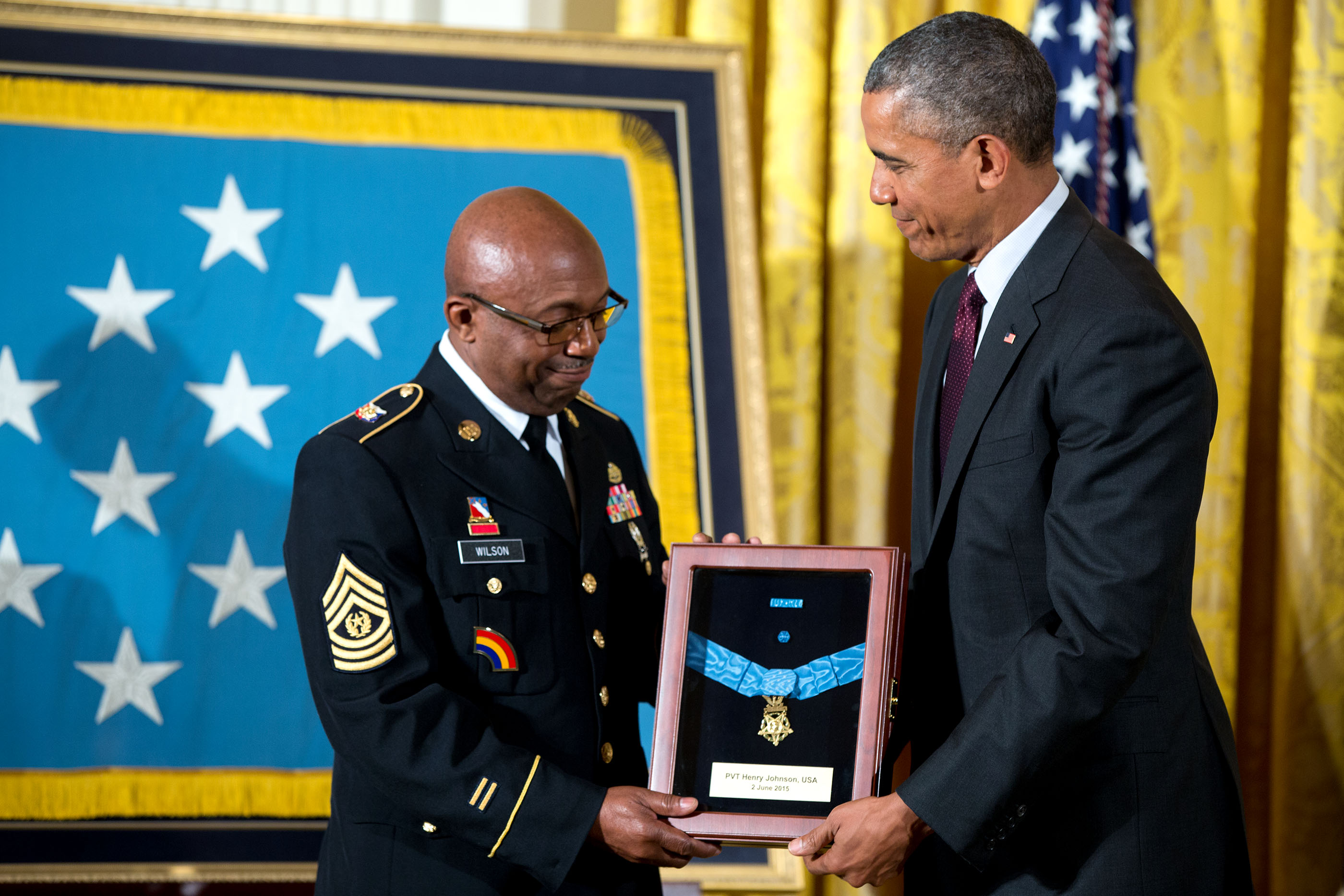 Command Sergeant Major Louis Wilson accepts the Medal of Honor from President Barack Obama awarded posthumously to Army Private Henry Johnson for conspicuous gallantry during World War I, at a ceremony in the East Room of the White House, June 2, 2015.