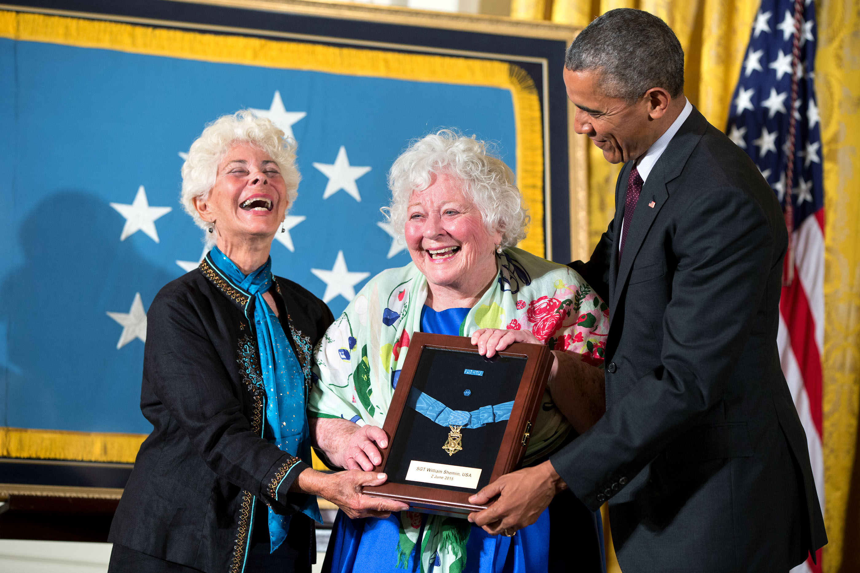 Ina Judith Bass (left) and Elise Shemin-Roth react after accepting the Medal of Honor from President Barack Obama on behalf of their father Army Sergeant William Shemin given posthumously for conspicuous gallantry during World War I, at a ceremony in the 