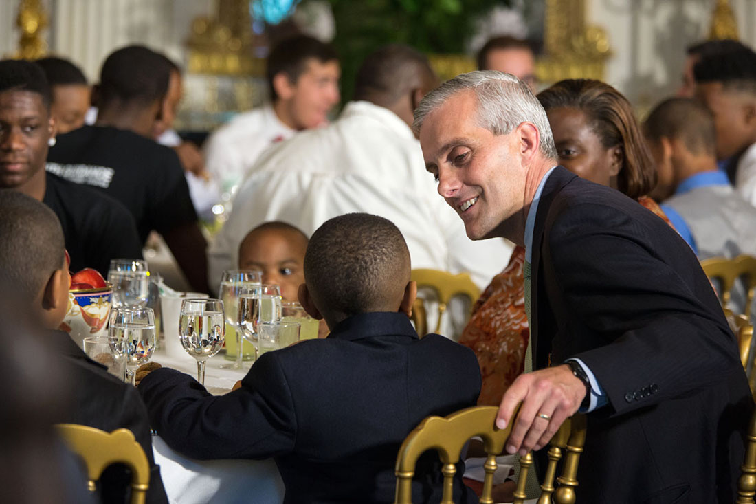 Chief of Staff Denis McDonough talks with a young participant during the Father's Day luncheon