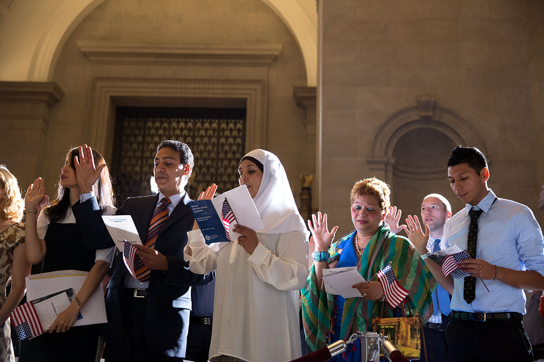 Petitioners are sworn in as new citizens at a naturalization ceremony at the National Archives, June 18, 2014
