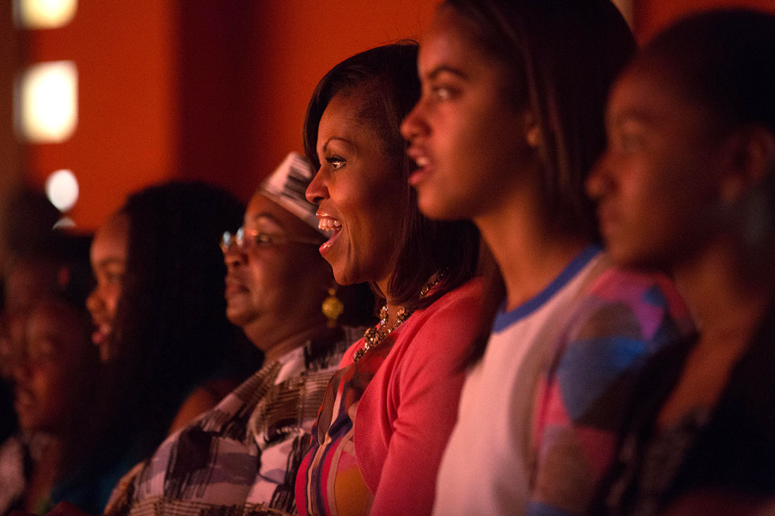 First Lady Michelle Obama and Salma Kikwete, along with daughters Malia and Sasha, watch the Baba Watoto performance
