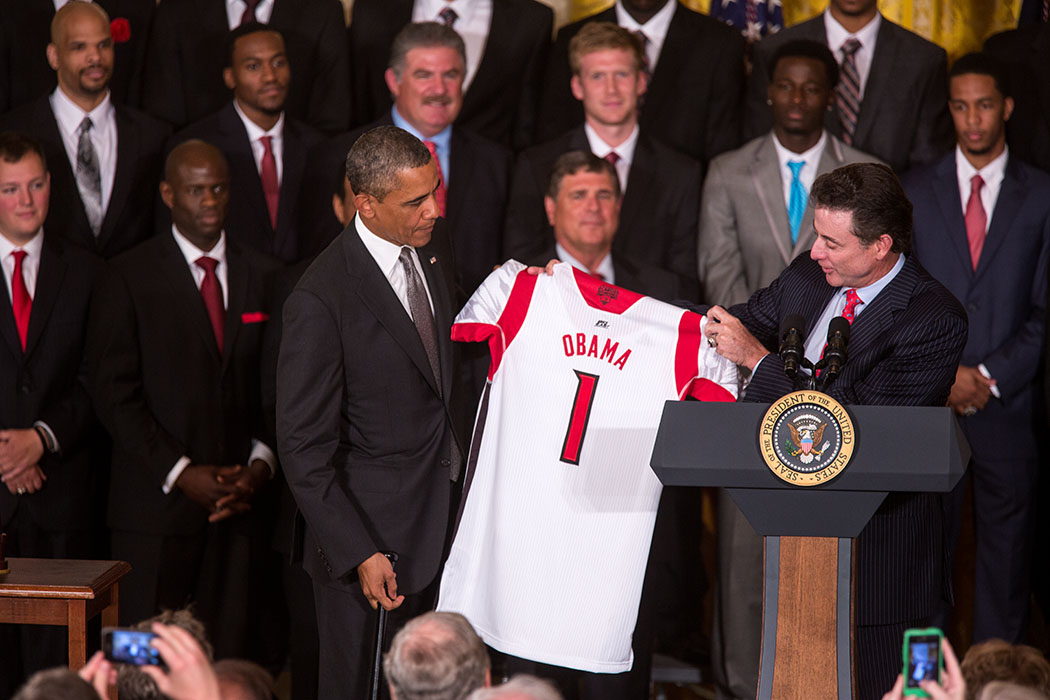 Coach Rick Pitino presents President Barack Obama with a team jersey as the President welcomes the NCAA Champion University of Louisville Cardinals to the East Room