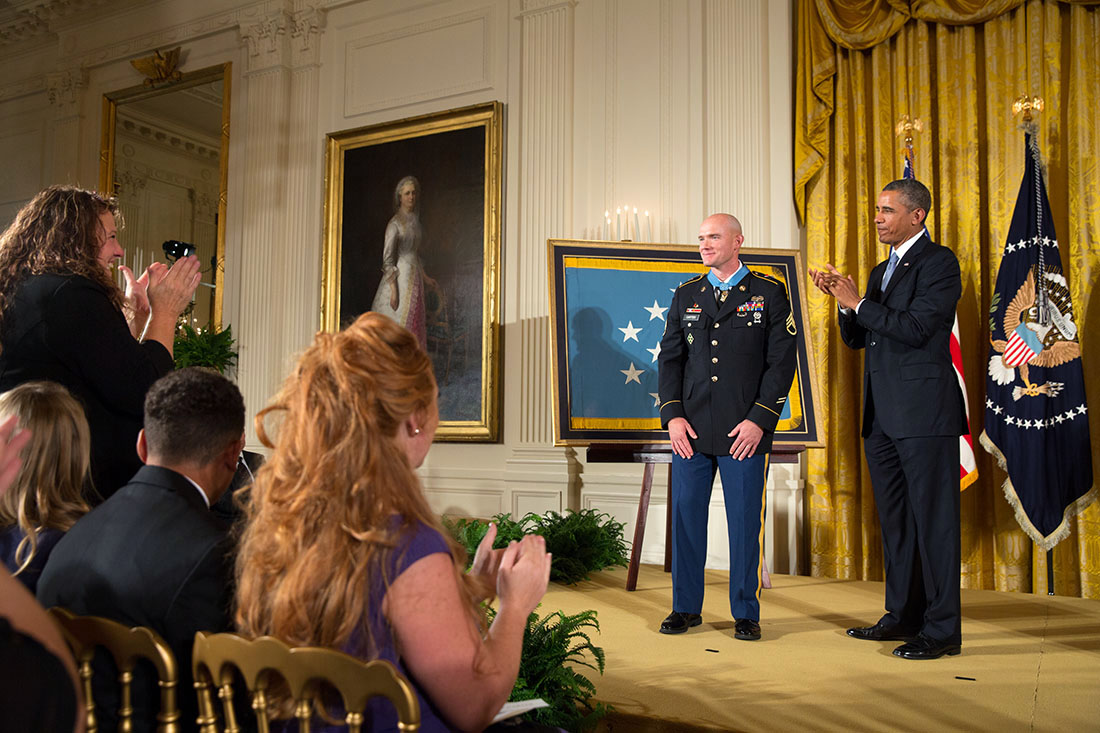 President Barack Obama applauds Staff Sergeant Ty M. Carter, U.S. Army, after presenting him with the Medal of Honor