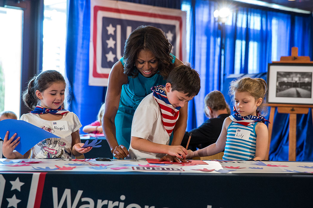 First Lady Michelle Obama joins children in an art project at the USO Warrior and Family Center