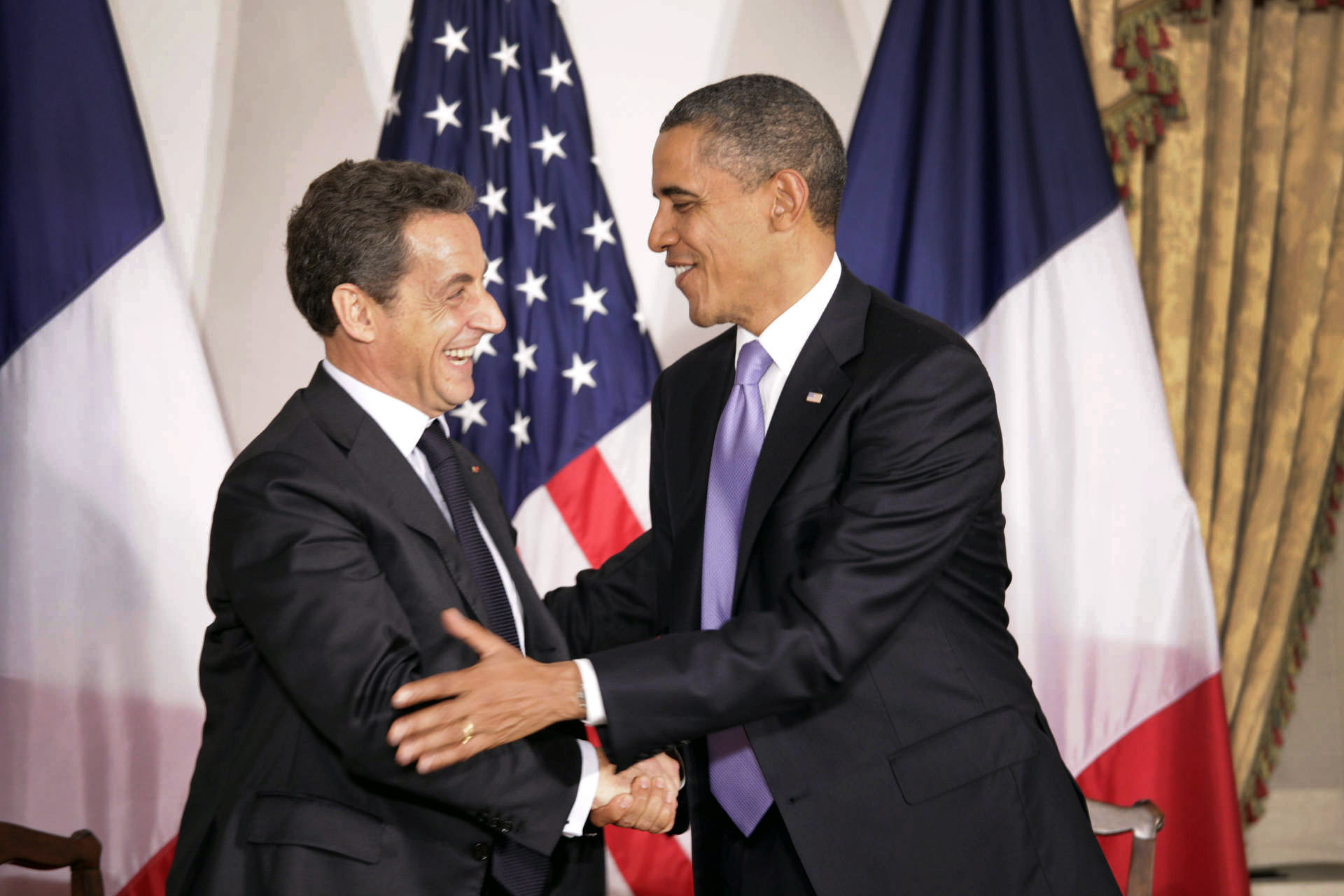 President Barack Obama greets President Nicolas Sarkozy of France