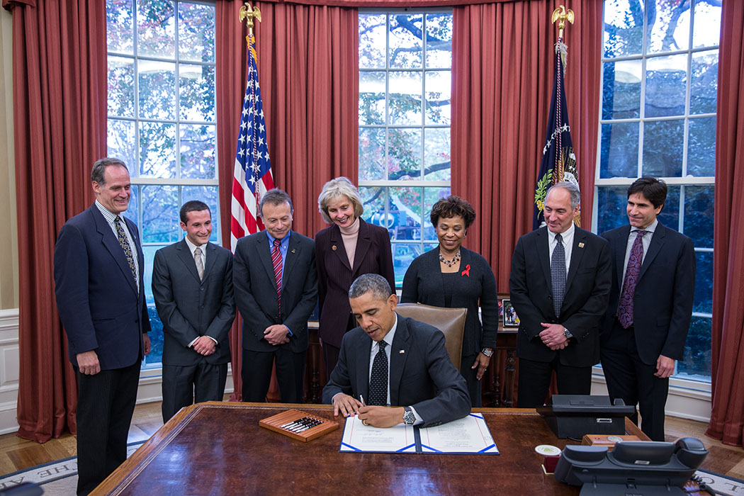 President Barack Obama signs S. 330: HIV Organ Policy Equity Act during a signing ceremony in the Oval Office