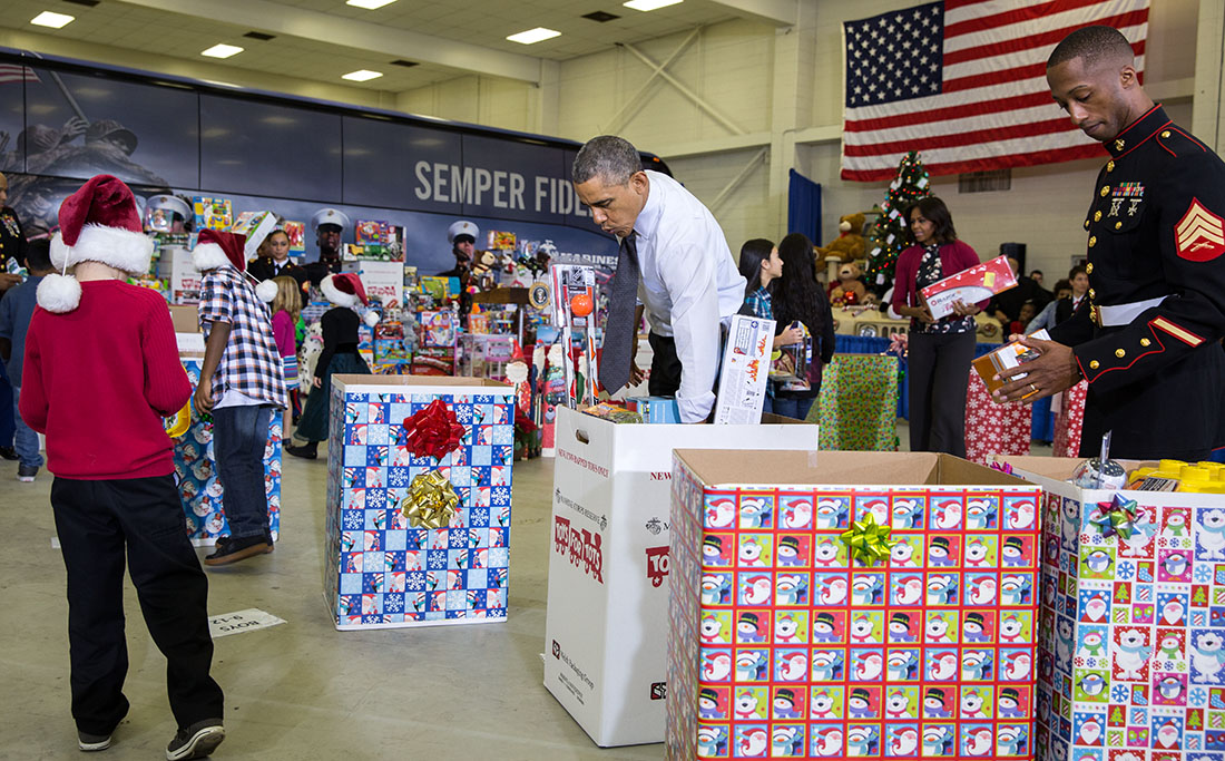The President and First Lady sort toys with U.S. Marines and children at Toys for Tots event