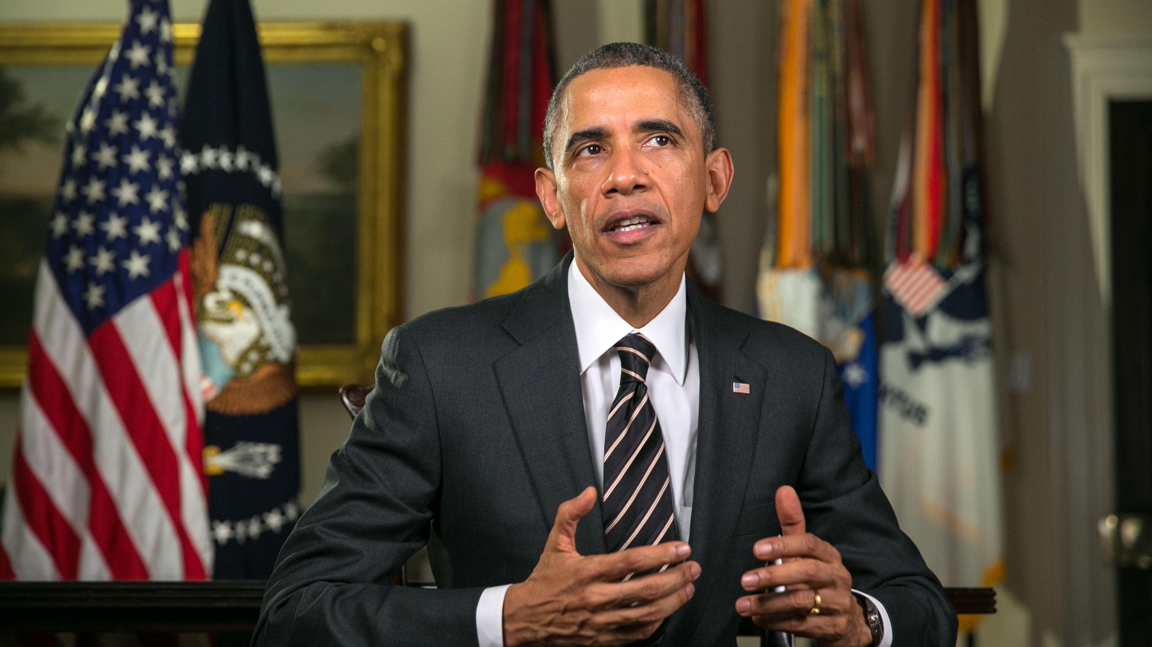 President Barack Obama tapes the Weekly Address in the Roosevelt Room of the White House, Dec. 12, 2014