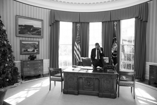 President Obama Talks on the Phone in the Oval Office