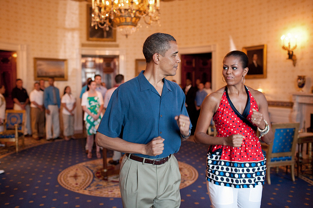 President Barack Obama and First Lady Michelle Obama pretend to march to music in the Blue Room