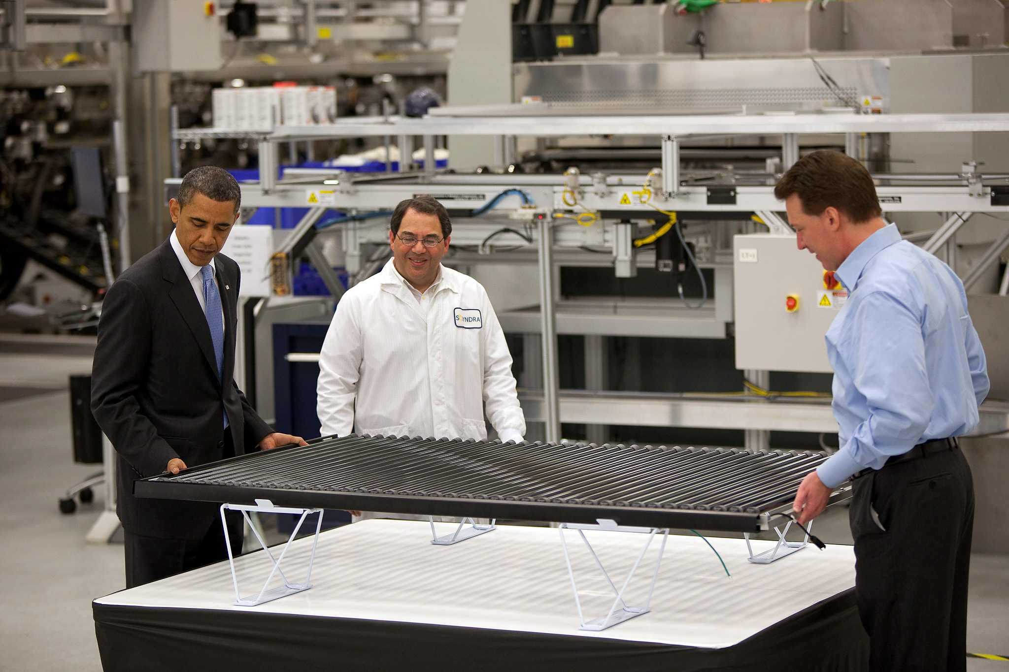 President Barack Obama examines a solar panel