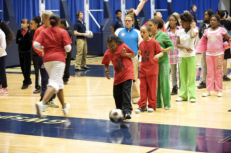 Girls playing soccer at Title IX event