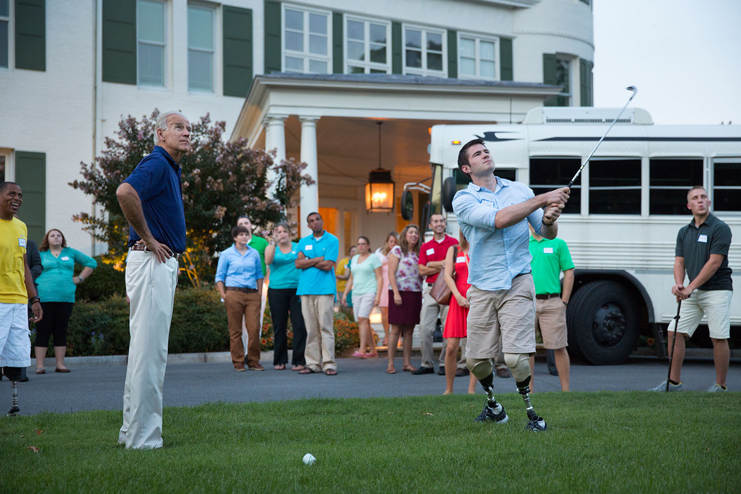 Vice President Joe Biden watches First Lieutenant Jason Church as he hits a birdieball