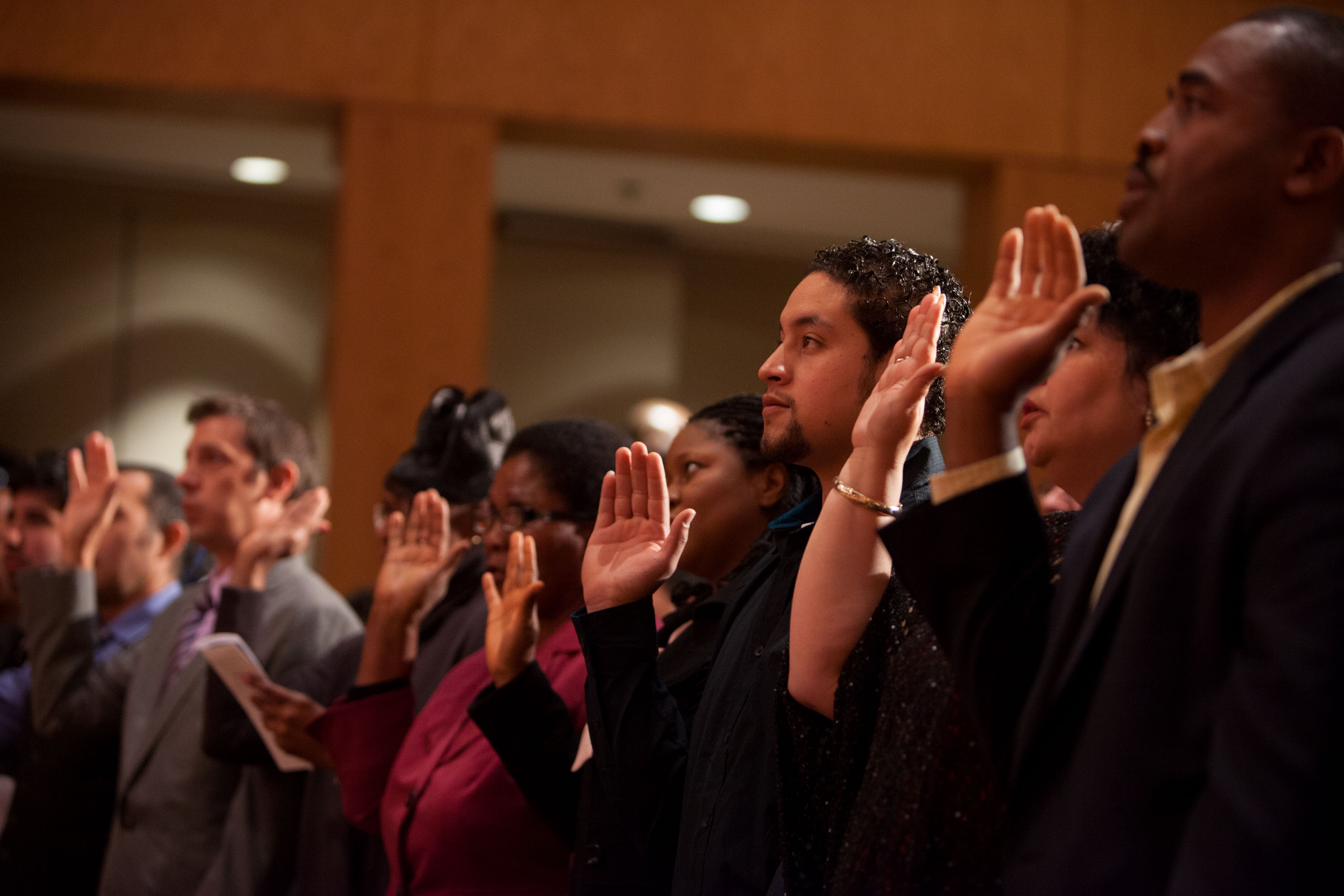New U.S. Citizens take the oath of allegiance during a naturalization ceremony 
