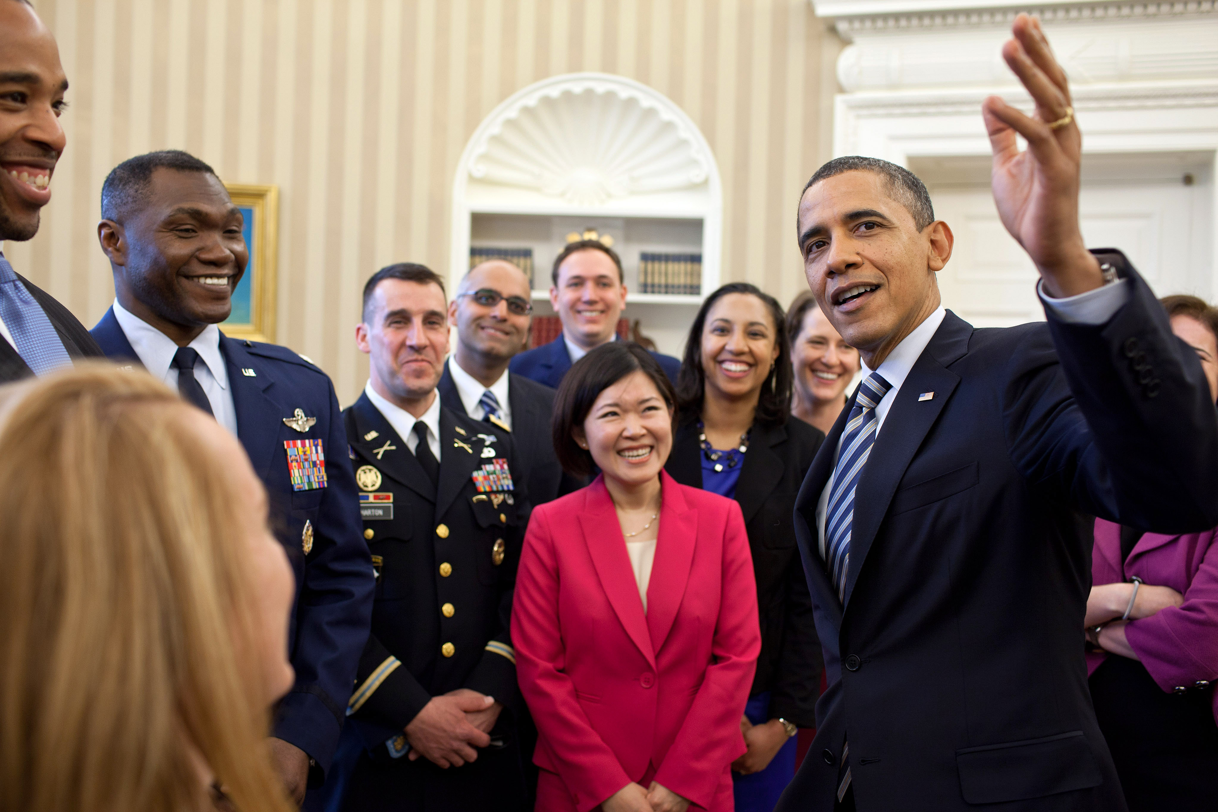 President Barack Obama shows the 2011-2012 class of White House Fellows around the Oval Office