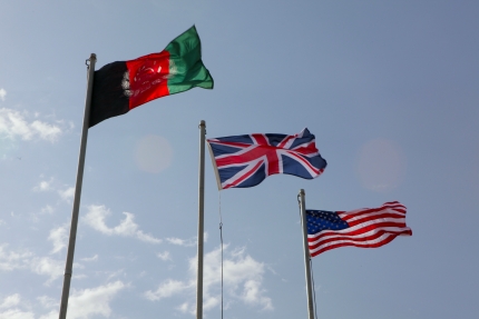 The Union Flag of the United Kingdom waves in the Afghanistan breeze between the Afghanistan and United States flags (March 13, 2012)
