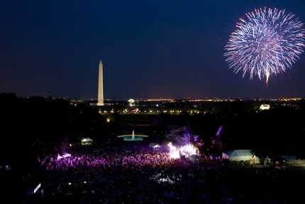A crowd watches as fireworks erupt over the National Mall (July 4, 2012) 