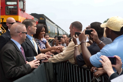 First Lady Michelle Obama greets people in the crowd at Kansas City Southern Railroad