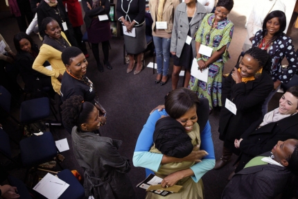 First Lady Michelle Obama receives a hug while meeting with Young African Women Leaders Forum