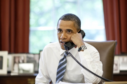 President Obama talks with the crews of the Space Shuttle Atlantis