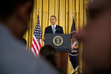 President Obama through the crowd at a press conference in the East Room