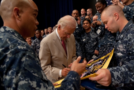 Vice President Joe Biden Signs a Flag for a Group of Sailors at Yokota AFB