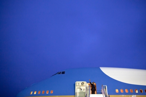 President Barack Obama Waves From The Top Of The Stairs