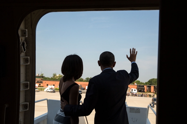 President Obama and First Lady Michelle Obama Wave as They Board Air Force One