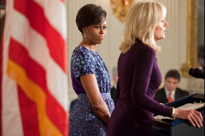 First Lady Text First Lady Michelle Obama listens as Dr. Jill Biden delivers remarks to ...