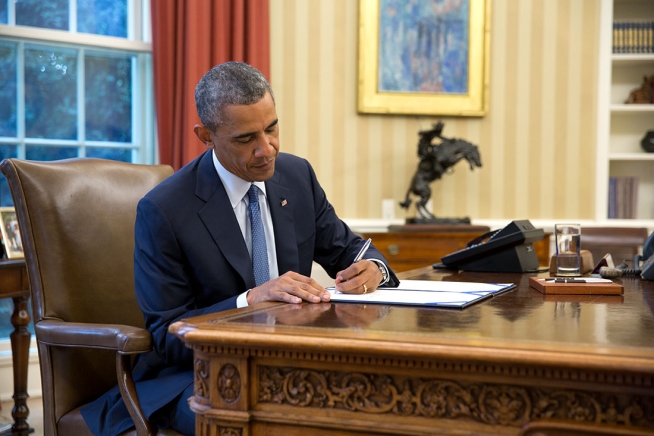 President Barack Obama signs S. 517, Unlocking Consumer Choice and Wireless Competition Act