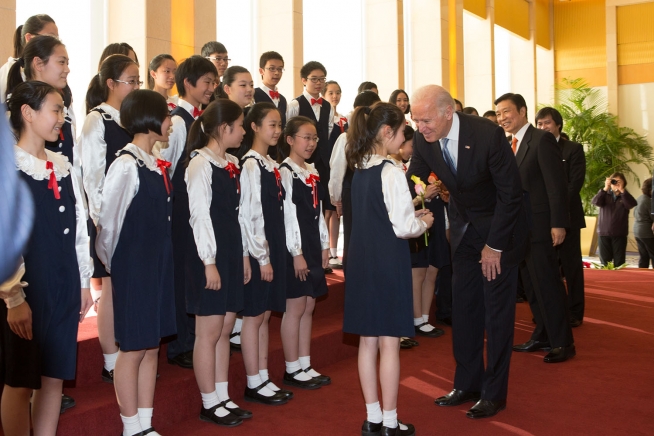 Vice President Joe Biden and Chinese Vice President Li Yuanchao greet members of 'The Children and Young Women Chorus of the China Symphony Orchestra', after they performed during a bilateral luncheon, at the Diaoyutai State Guesthouse, in Beijing China, December 5, 2013. (Official White House Photo by David Lienemann)