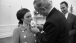 President Lyndon B. Johnson pins a flower on the lapel of figure skater Peggy Fleming